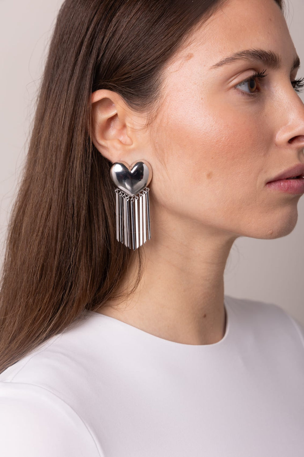 Model in profile wearing CHARM statement tassel earring